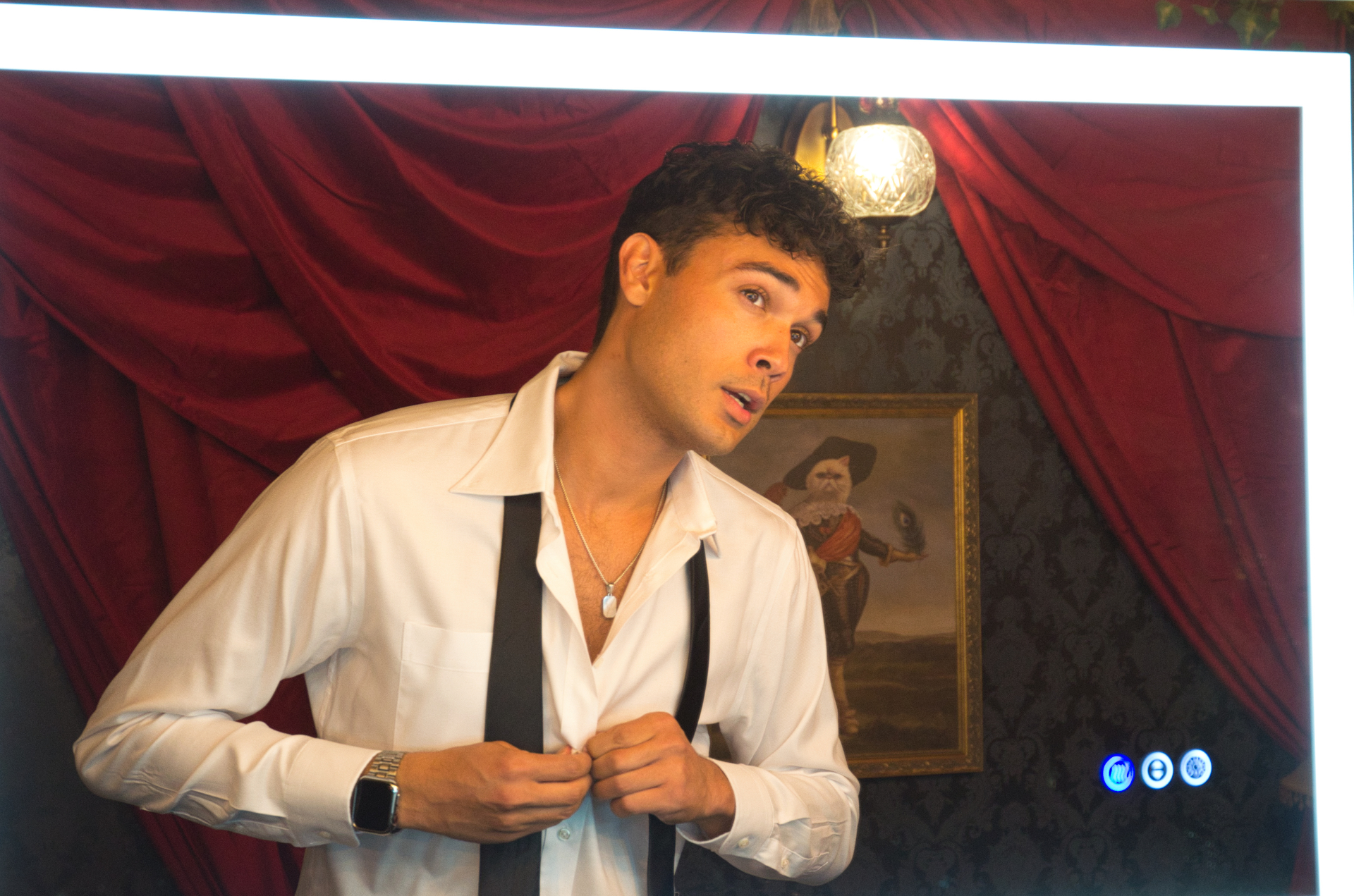 Aaron Fowler getting ready in a vintage mirror